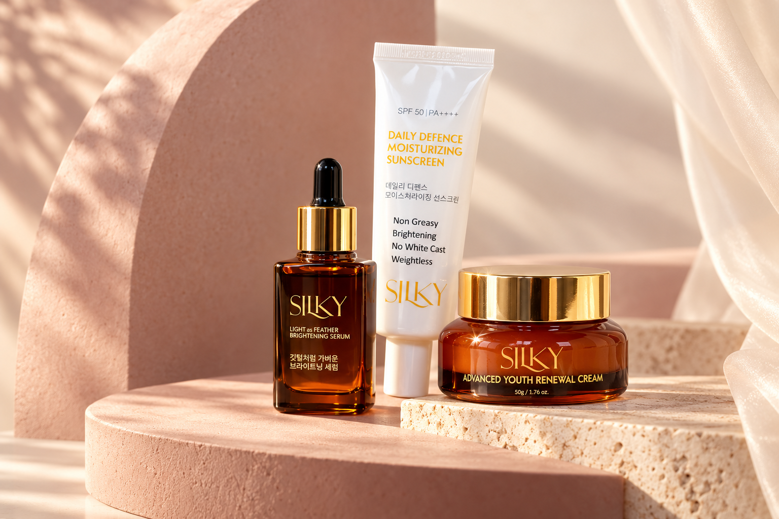 SILKY serum, cream and sunscreen arranged on warm blush pedestals